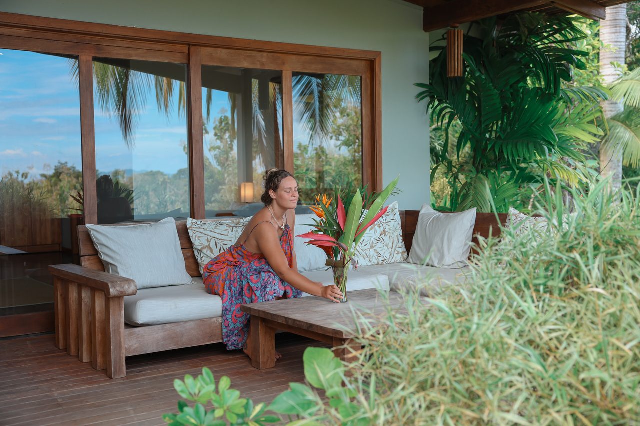 Guest arranging flowers on the deck at Taru
