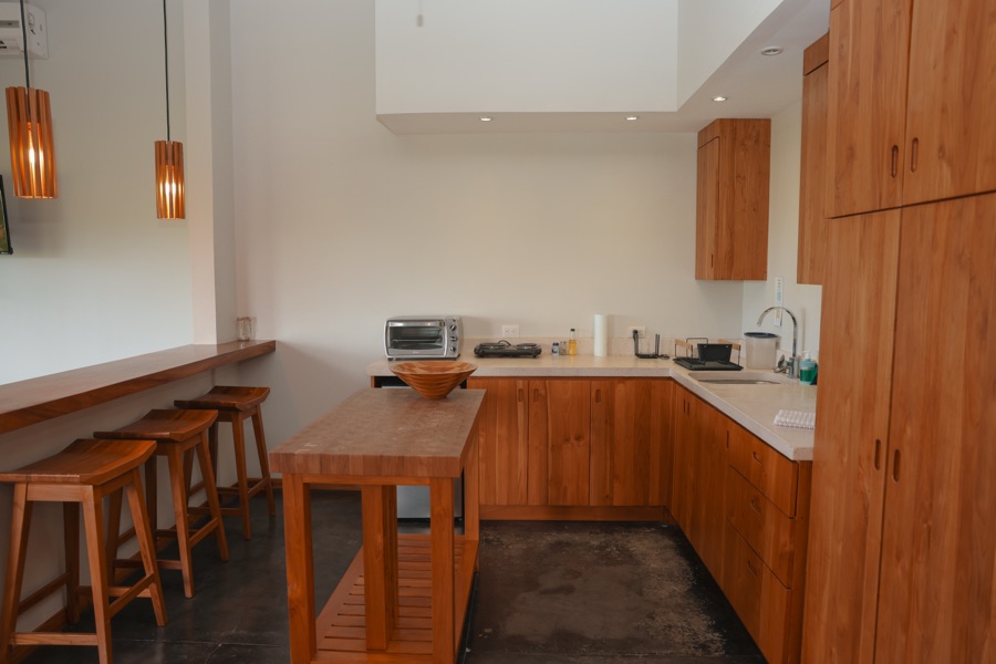 Sunrise Studio kitchen with wood cabinets, island and bar stools